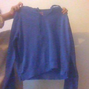 A blue jacket, the inside of the jacket is striped pink and blue.